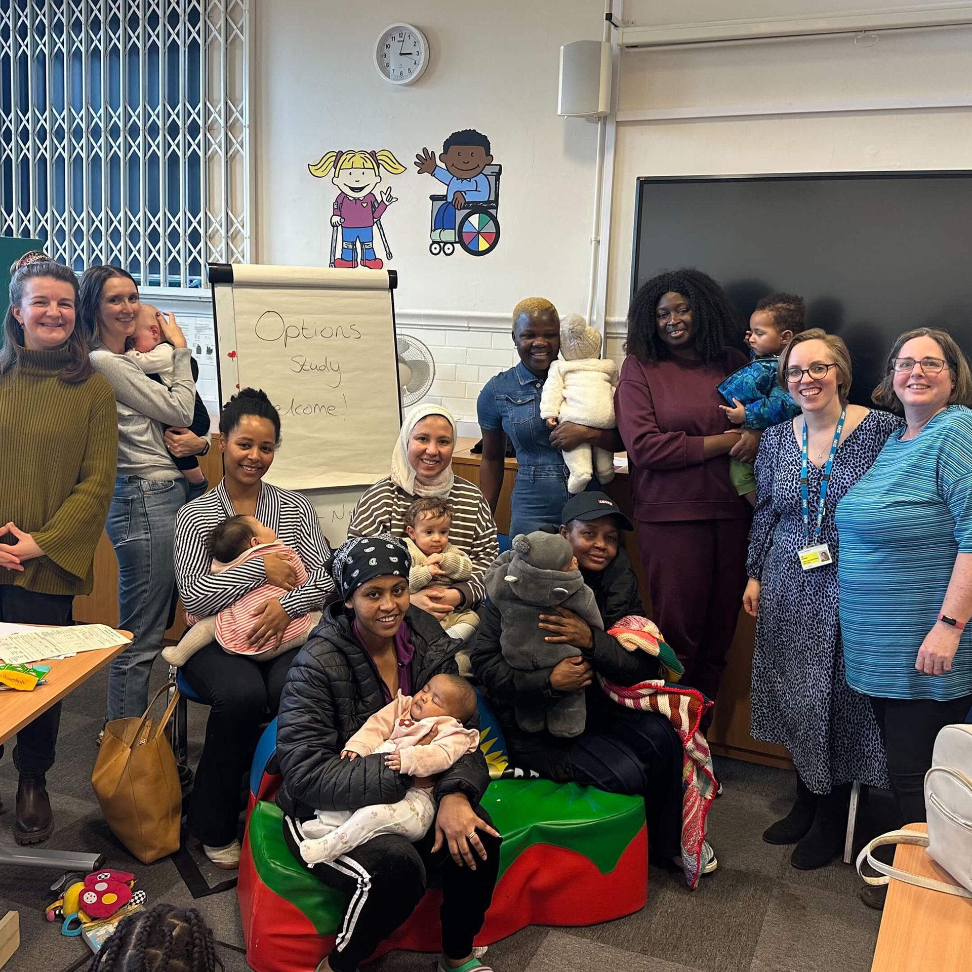 Birth Options group of people taking a picture after discussion with white board behind them