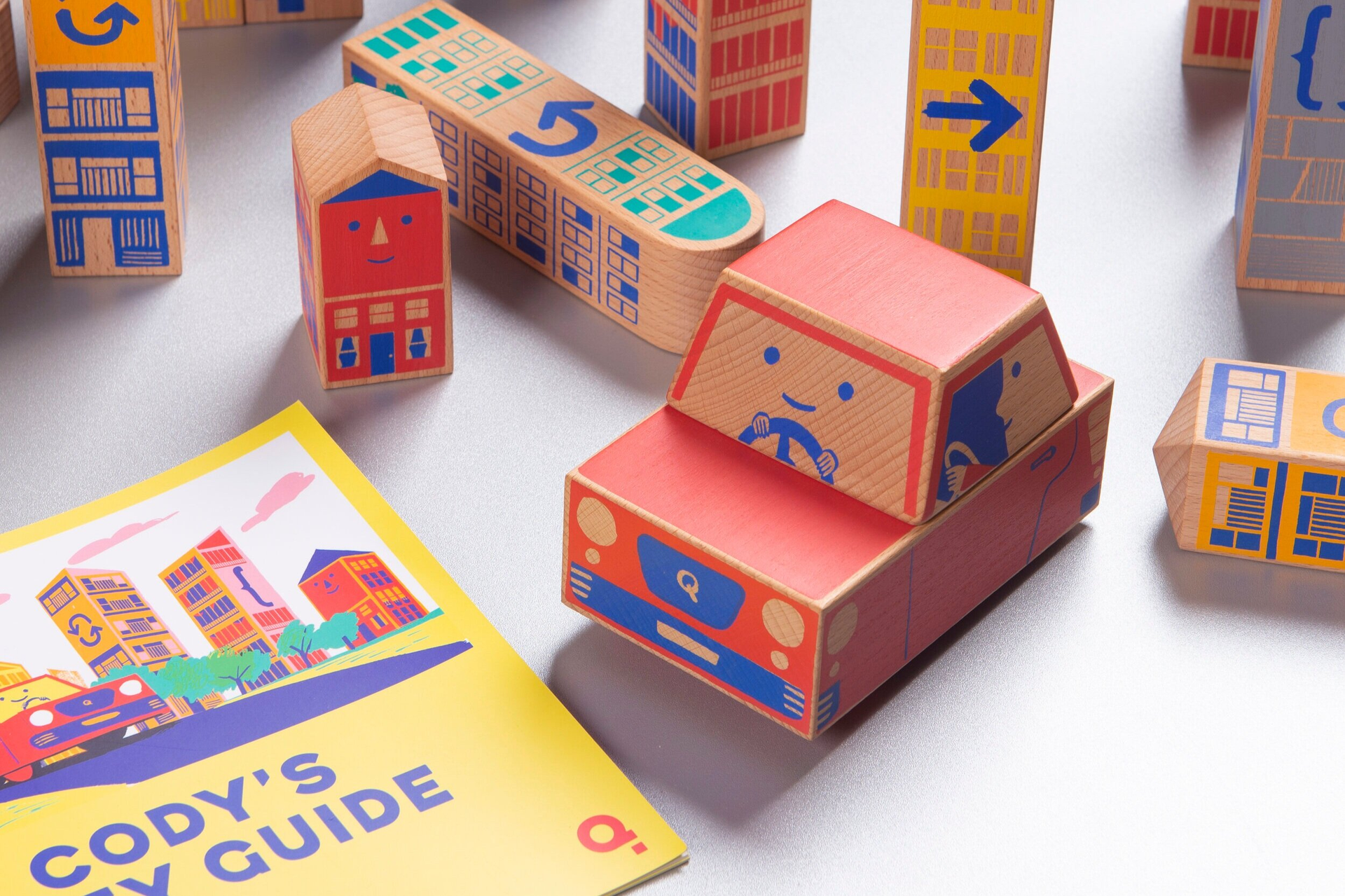 Cody block wooden car in a table with wooden blocks and a guide book