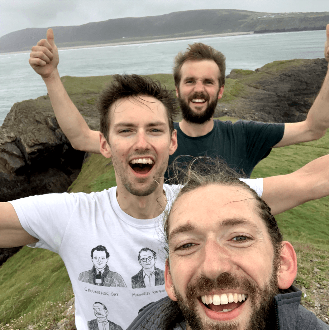 Directors close to a cliff near the ocean